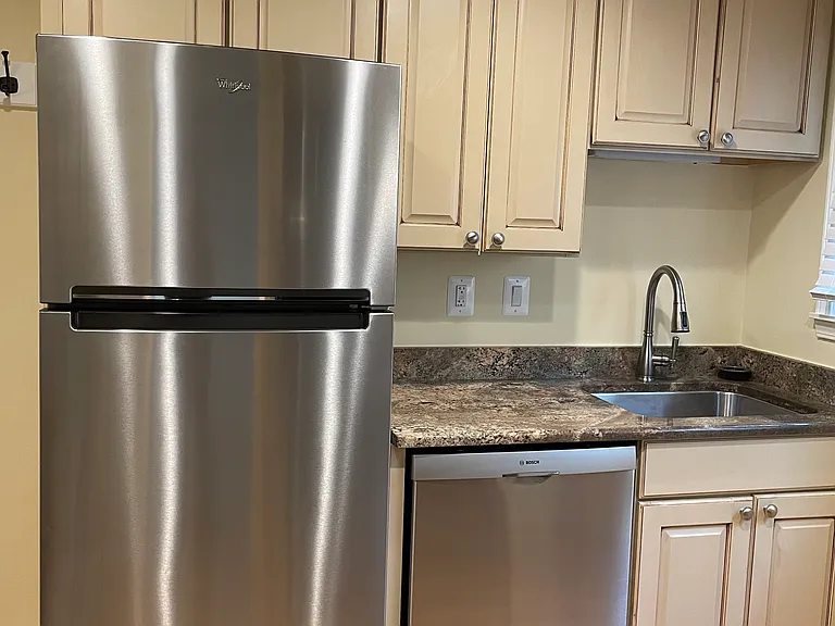 Beautiful kitchen with granite counter tops and newer dishwasher.