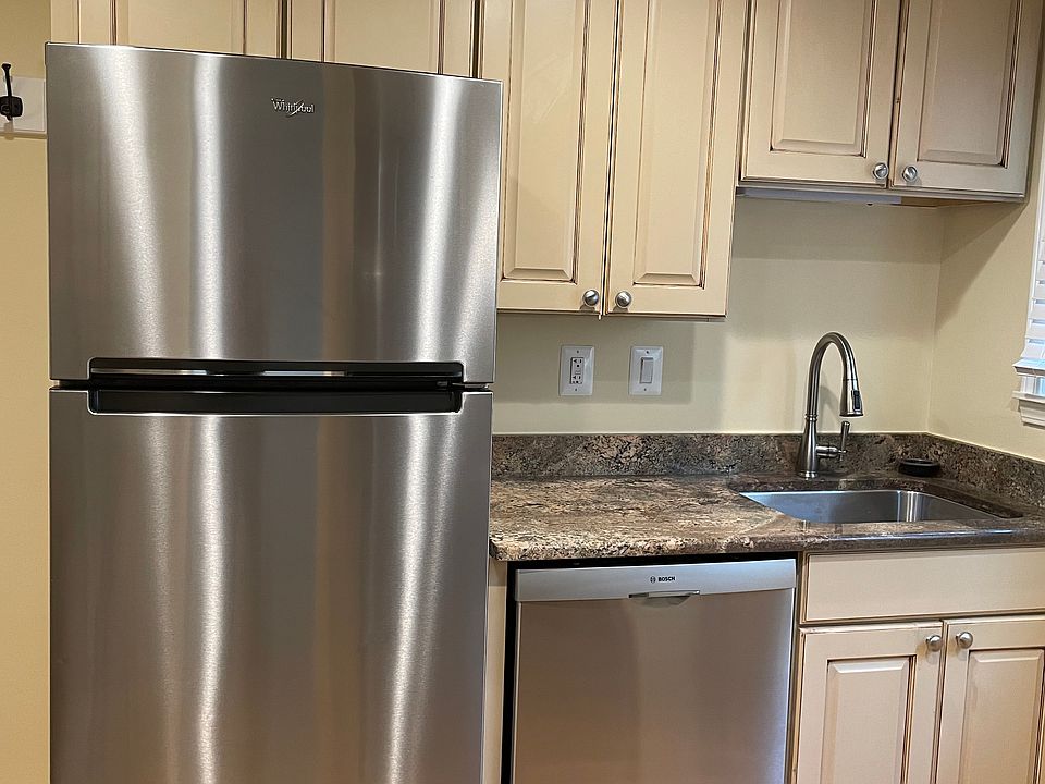 Beautiful kitchen with granite counter tops and newer dishwasher.