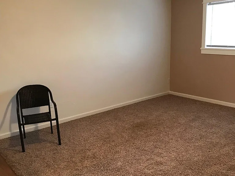 This picture was also taken in Apt #8 & included here only to show the depth of the living room in Apt #7. Carpet & laminate flooring in Apt #7 is different as is shown in the other photos here.