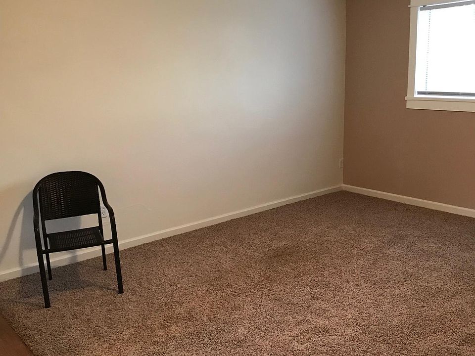 This picture was also taken in Apt #8 & included here only to show the depth of the living room in Apt #7. Carpet & laminate flooring in Apt #7 is different as is shown in the other photos here.