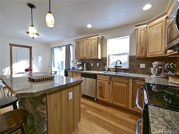 Granite counters, ledge stone, full height backsplash, hickory cabinets, the works!