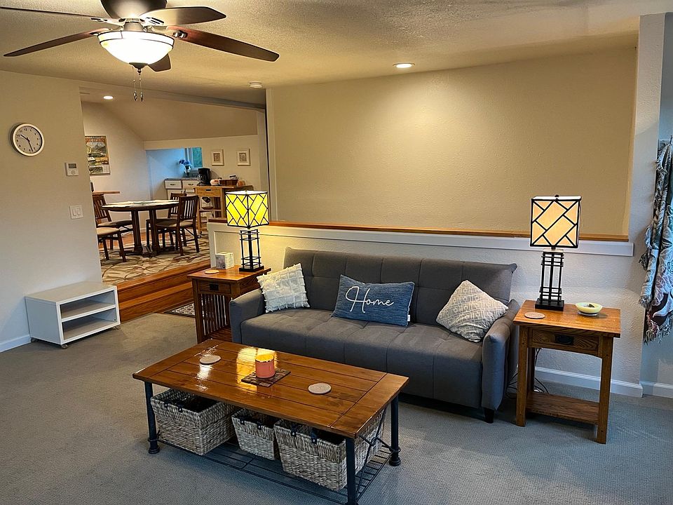 Living room of unit looking towards dining area and entry stairs.