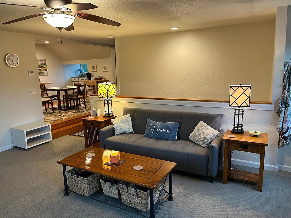 Living room of unit looking towards dining area and entry stairs.