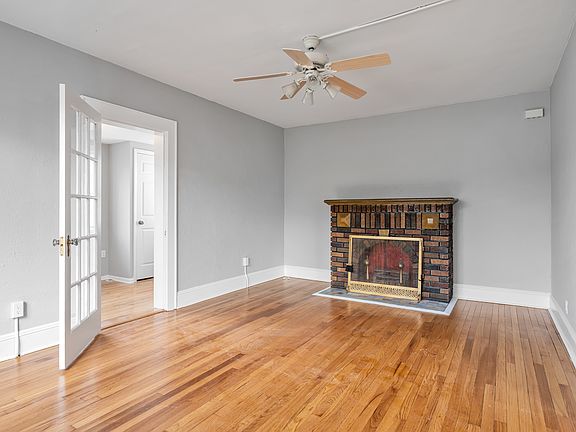 Living Room with faux Fireplace & french door to 2nd BR or den