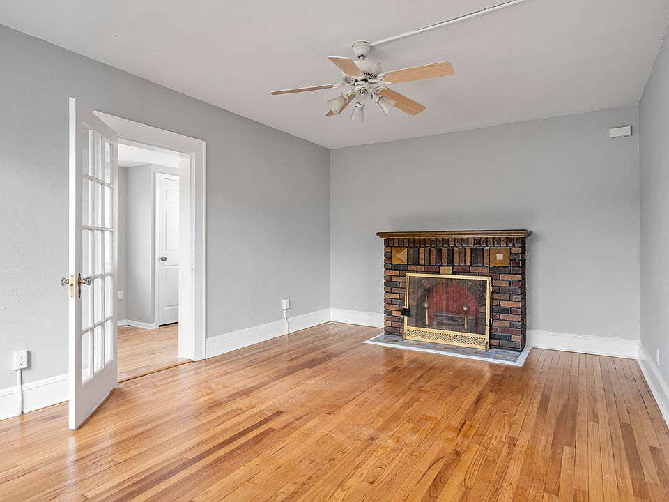 Living Room with faux Fireplace & french door to 2nd BR or den