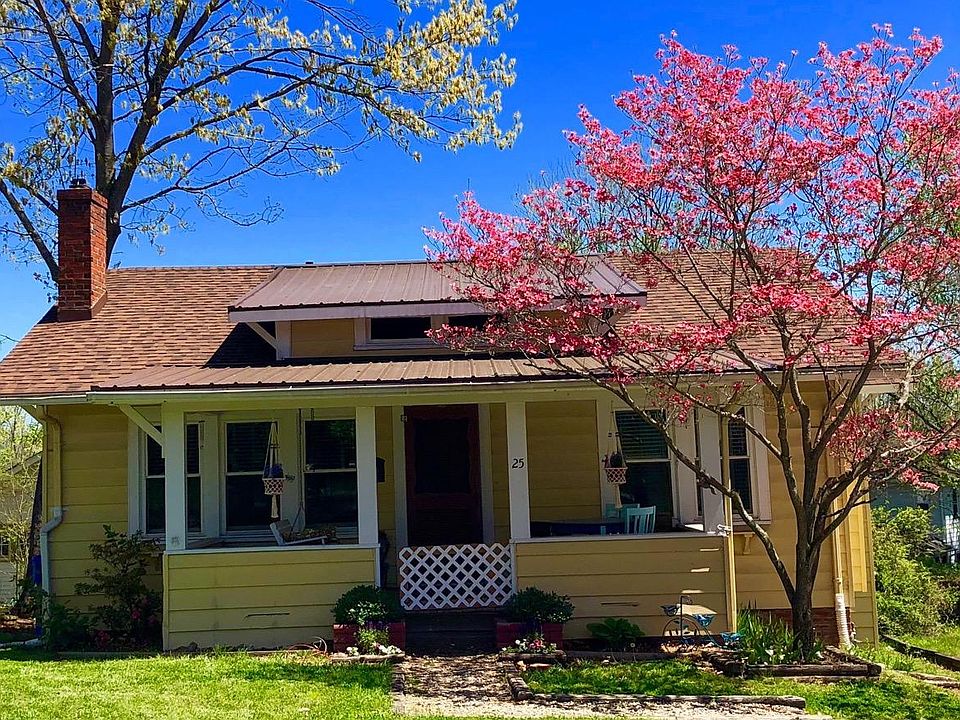 House in spring with red dogwood blooming.
