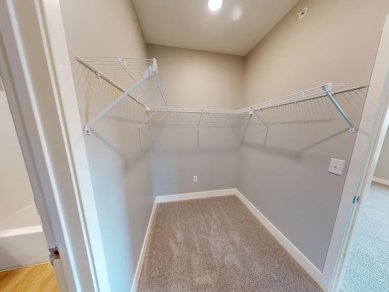 The primary en suite includes a walk-in closet in between the bedroom and bathroom. The primary en suite includes a walk-in closet in between the bedroom and bathroom.