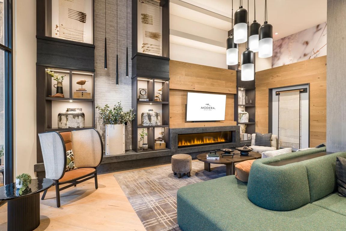 Relax fireside in this cozy and modern resident lounge, perfect for quiet mornings or unwinding with friends.