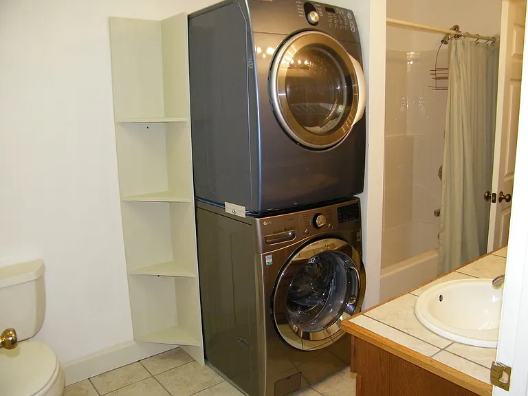 Washer/dryer provided. Double vanity and shower/tub combo. Entrance from both bedroom and greatroom.