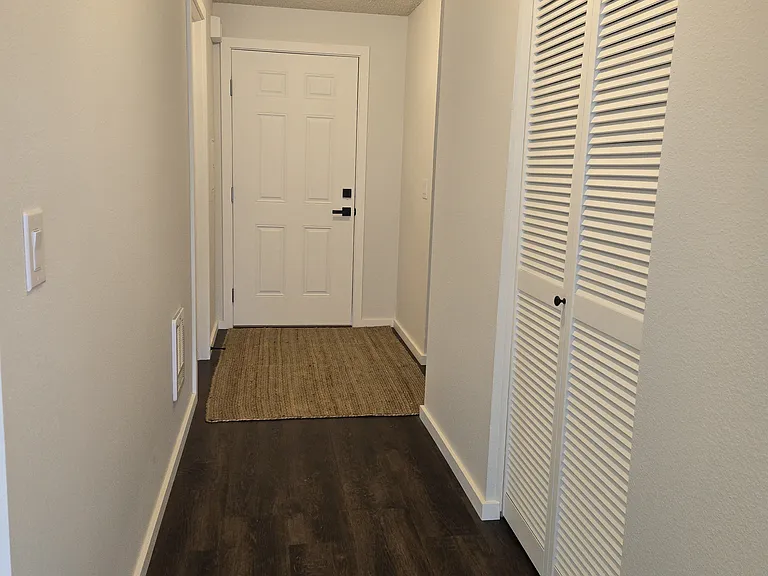 View from front room/dining to front door.
Entry coat closet on right. (rug not included).