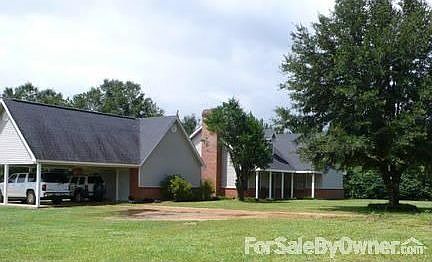 view from left of front yard
						:
						The kitchen window below looks out into the chimney alcove.