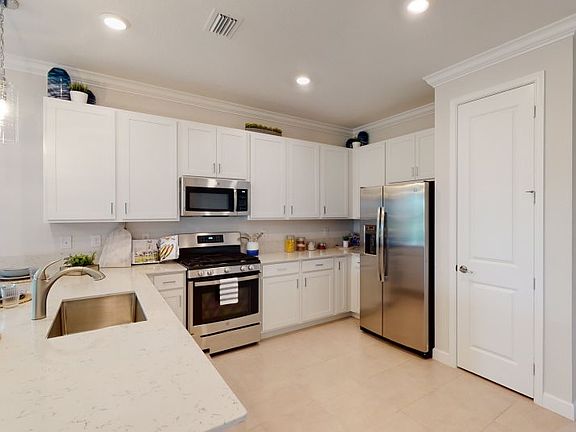 With ample cabinetry, a separate pantry and stylish peninsula that offers bar seating and counter sp