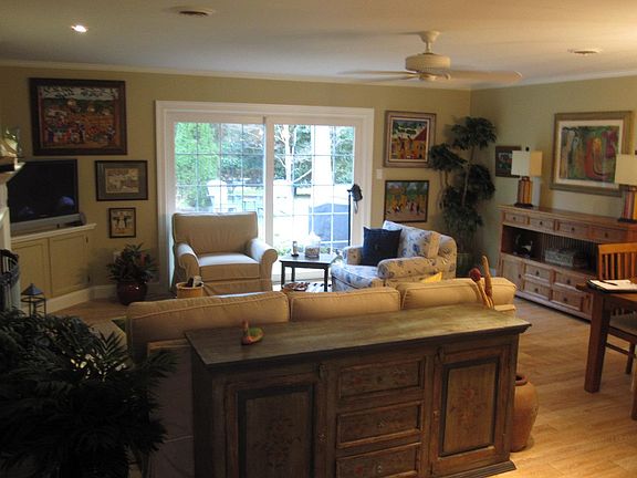 The Living room looking out to the patio and garden. The furnishings are not as shown.