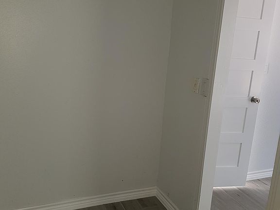 Inside of large closet looking towards bedroom