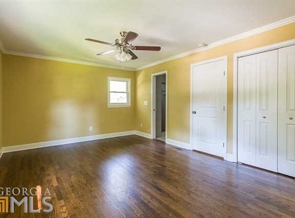 Large master bedroom features separate his and her closets.