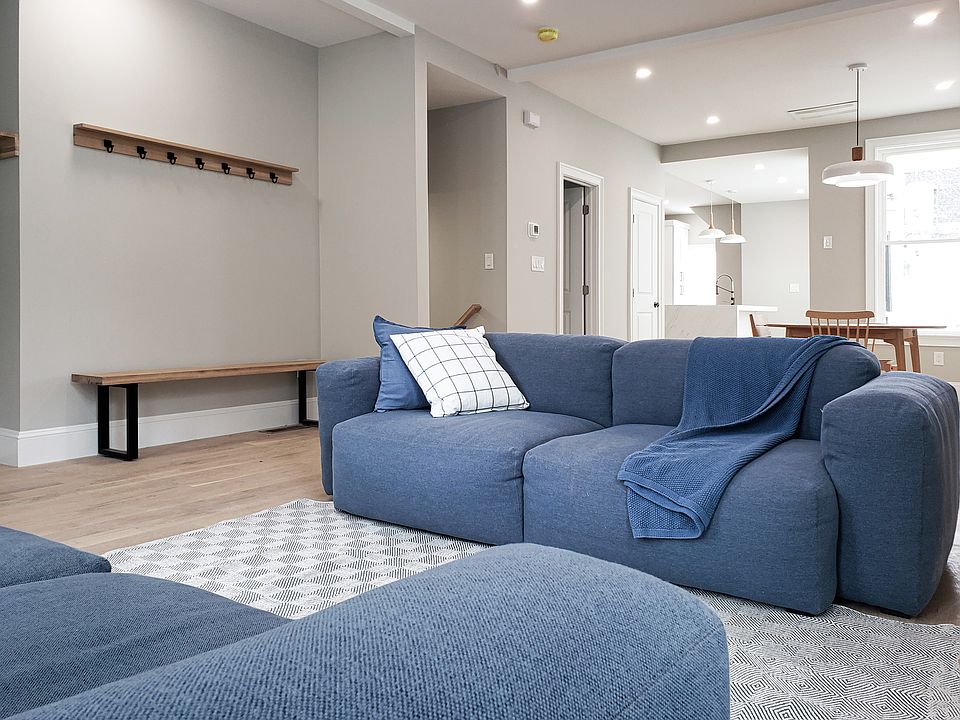 Living room, dining room, and kitchen on the ground floor- 10' tall ceiling, large windows (3' by 7'); designer hay sofa, design white oak table, kitchen with back yard deck;
