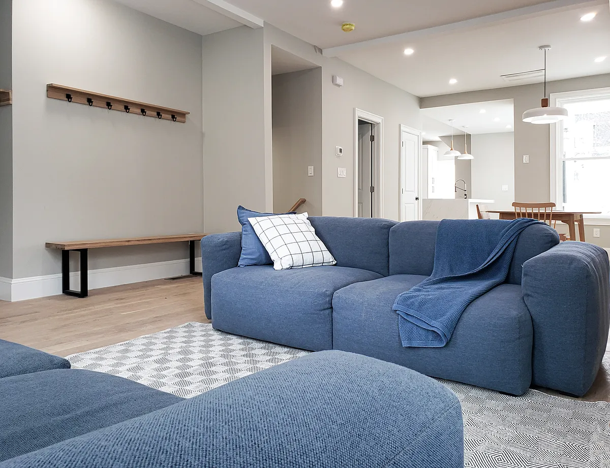 Living room, dining room, and kitchen on the ground floor- 10' tall ceiling, large windows (3' by 7'); designer hay sofa, design white oak table, kitchen with back yard deck; - 97 Trenton St #1