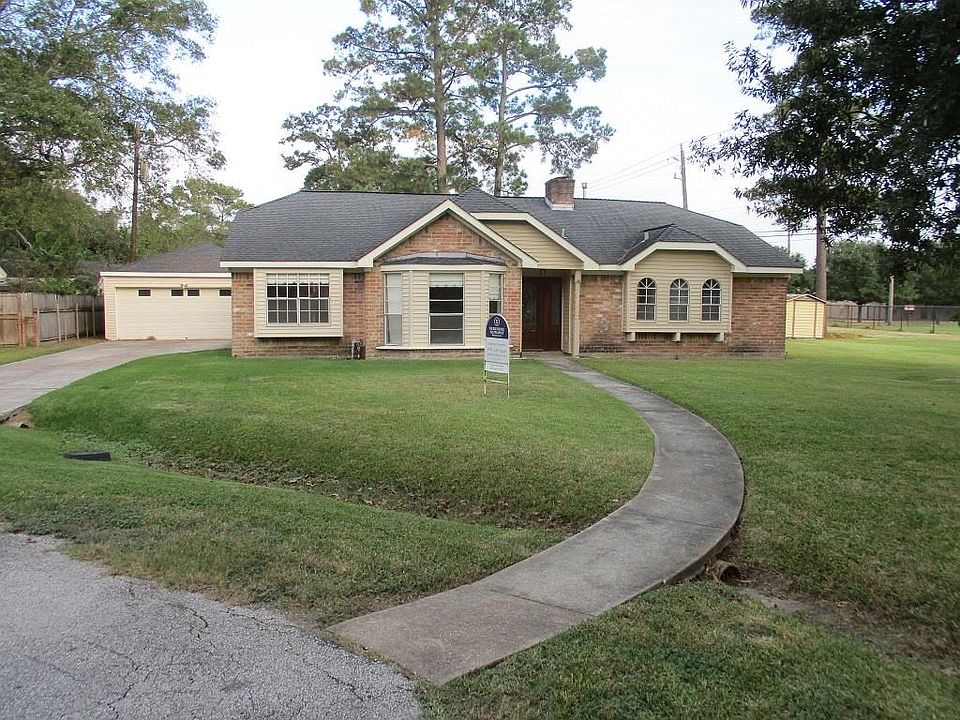Front shot of home from cul-de sac. Long driveway on left of home leads to 2 car detached garage offering lots of parking. Entire interior has new paint including closets.