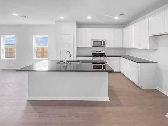 The Waring III- Kitchen with Large Island. Sample image for illustration upgrades, options, and col