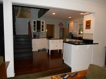 Beautiful modern kitchen with second set of stairs going up to a master suite)