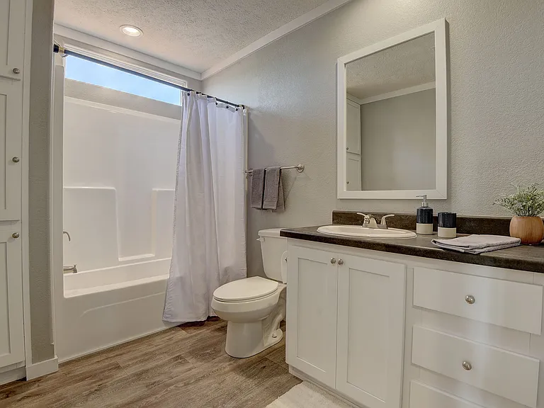 Clean, bright bathroom featuring a full tub and shower combo, modern vanity, and ample storage_designed for comfort and everyday convenience.