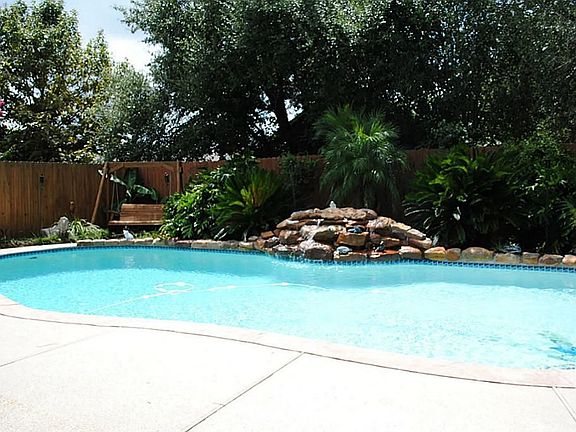 Beautiful pool has a 2 horsepower pump and a rock fountain.