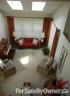 Cathedral Ceilings : Ceilings rising to 21 ft give an airy feeling to the formal living room area.