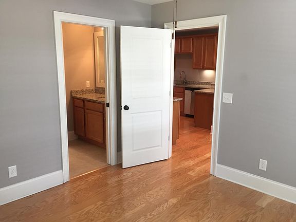 Bedroom looking towards bathroom and living/kitchen