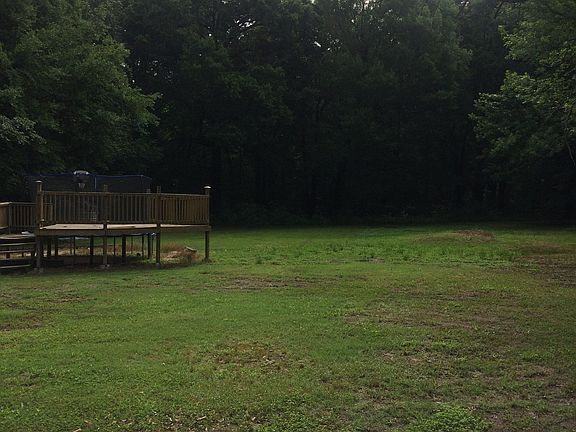 Large back yard with trees