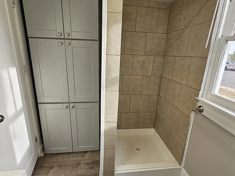New bathroom with quartz countertops and tons of built-in storage.