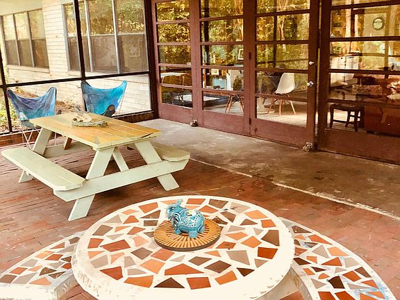 Large doors off the living room open up to Gigantic screened patio for outdoor dining