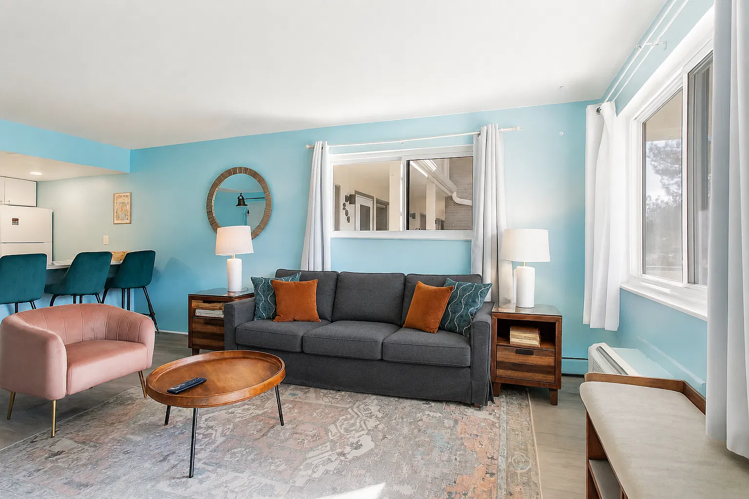 Sink into the soft couch, bask in the natural light, and enjoy the cheerful, welcoming energy that makes this space feel like a true getaway.