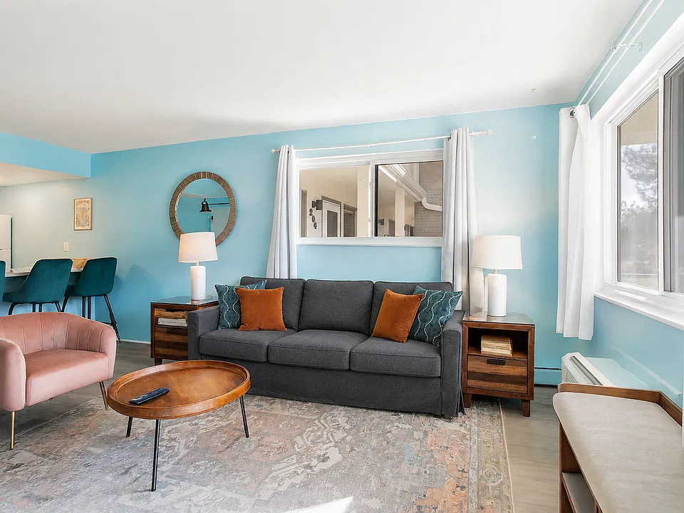 Sink into the soft couch, bask in the natural light, and enjoy the cheerful, welcoming energy that makes this space feel like a true getaway.