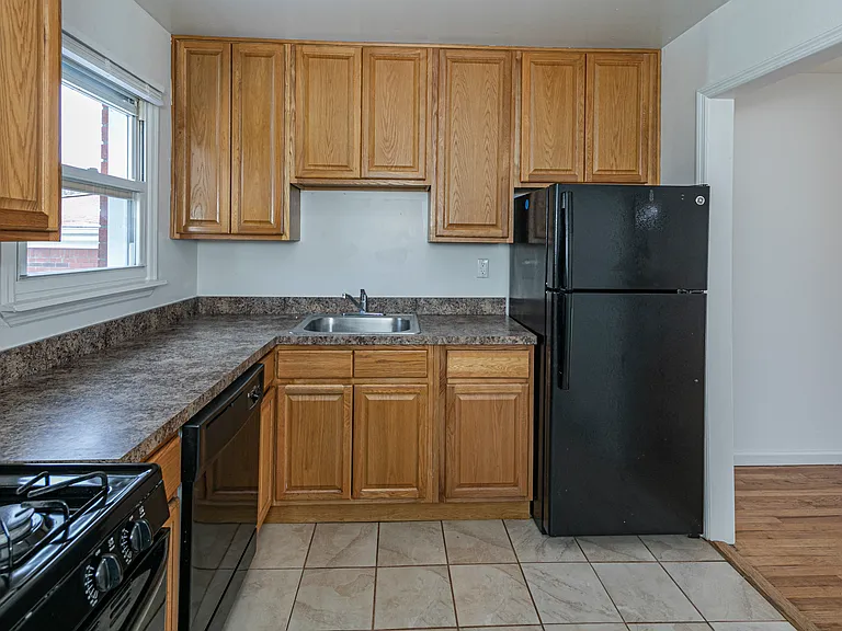 Eat-in kitchen with oak cabinets featuring black appliances