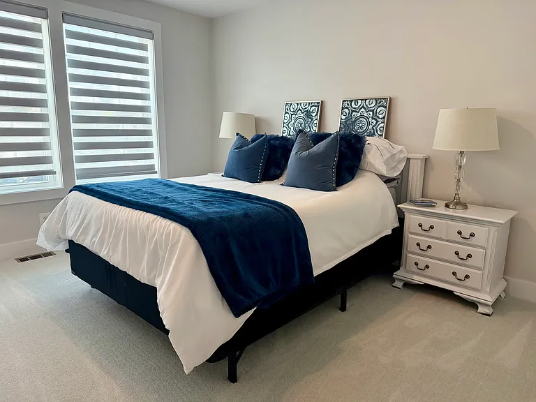Queen size bed guest room with high quality mattress and linens