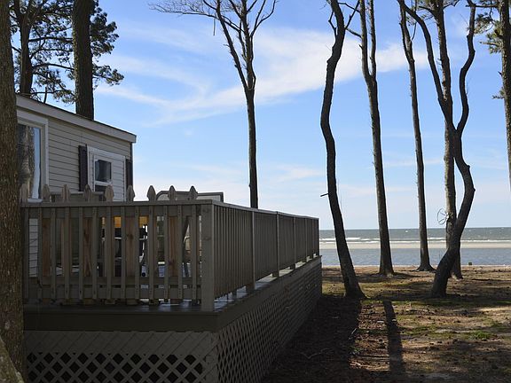 Side of home with view of sandbar. Beach access is just a few feet away from the front of the home.