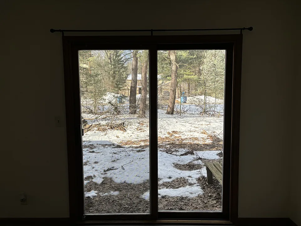 Inside view livingroom slider to side yard.