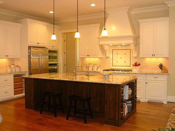 Large open kitchen with huge island topped Polar Crème Granite