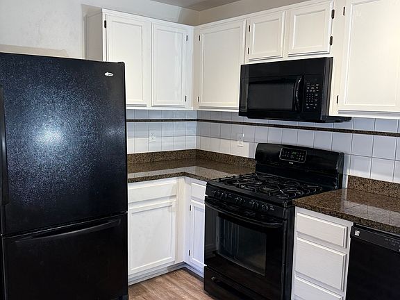 Kitchen - complete with granite countertops, oven, microwave, dishwasher and refrigerator.