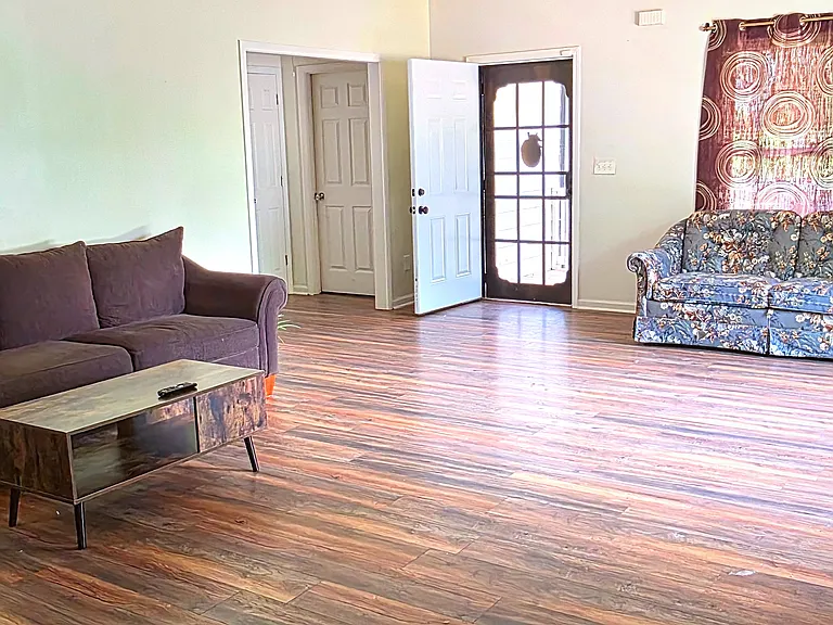 Shared space - spacious living room with couches, TV, coffee table, sofa bed and dining table
