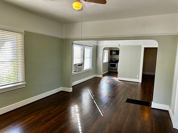 Freshly Painted Great Room and Dining Room Photo #1 Showing Arched Opening into Kitchen