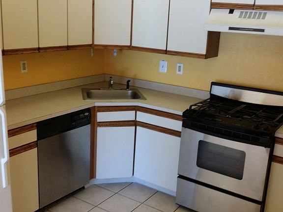 Kitchen with stainless steel gas range and dishwasher
