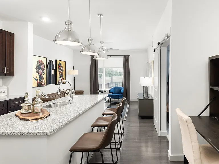 Granite-Style Kitchen Island, Sliding Barn Doors, Open Living Spaces and Modern Pendant Lighting