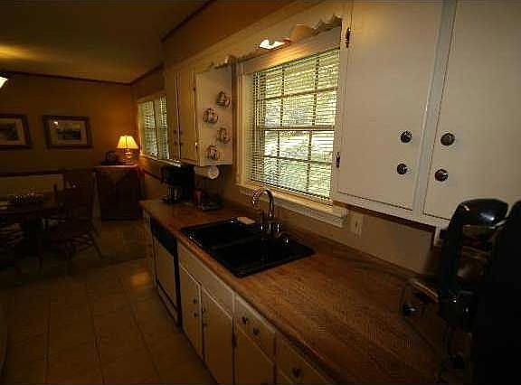 This galley kitchen has updated fixtures and appliances, plus a tile floor.