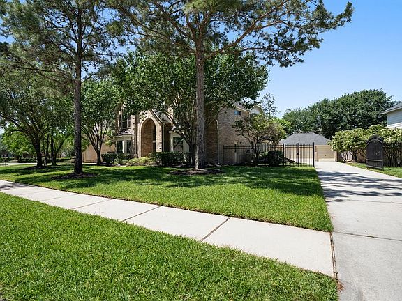 The home sits on an amazing lot with established shade trees, gated driveway lead to 3-car detached garage. The home has a recent roof.