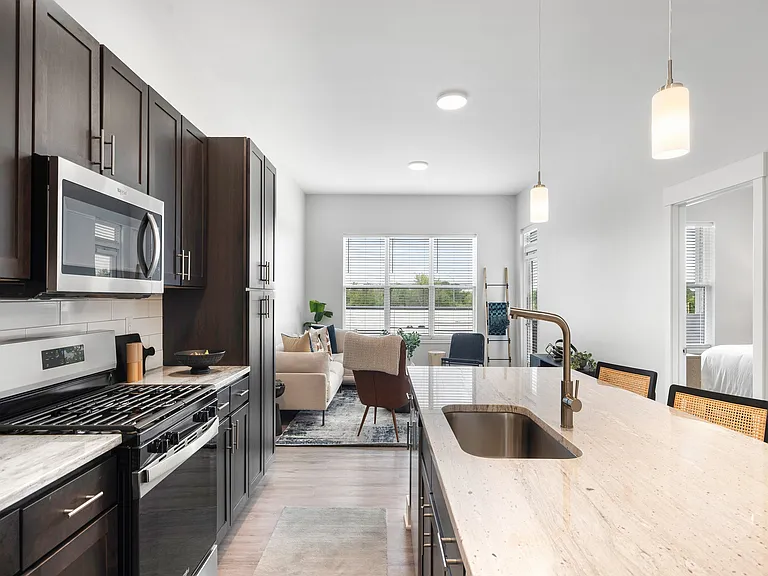Open-plan kitchen with island and breakfast bar seating