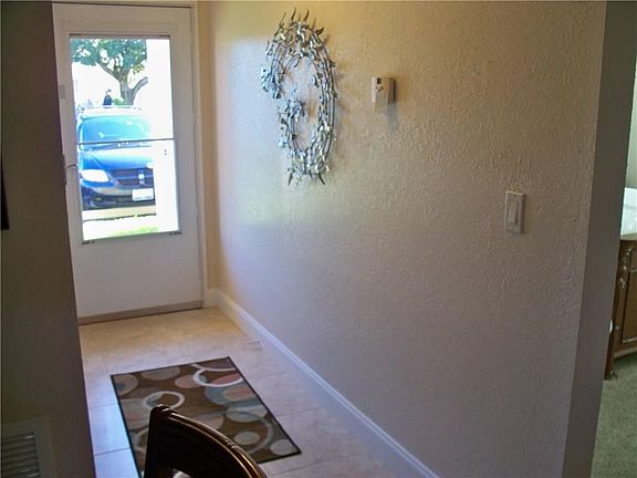 Tiled foyer with glass/screen door