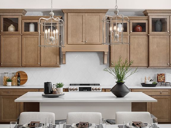 Kitchen with pendant lighting and stunning hood vent