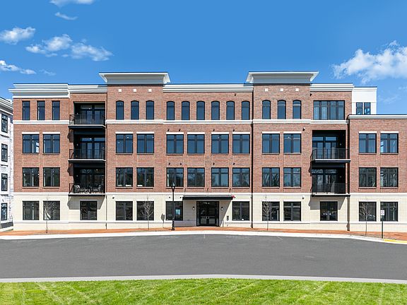 Our newest building stands tall while construction continues on the neighboring condominiums.