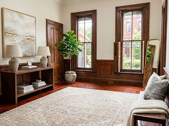 Large living space with restored original hardwood and high ceilings